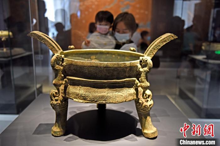 6月11日，安徽淮南市民在寿县安徽楚文化博物馆内欣赏青铜器铸客升鼎。　陈彬 摄